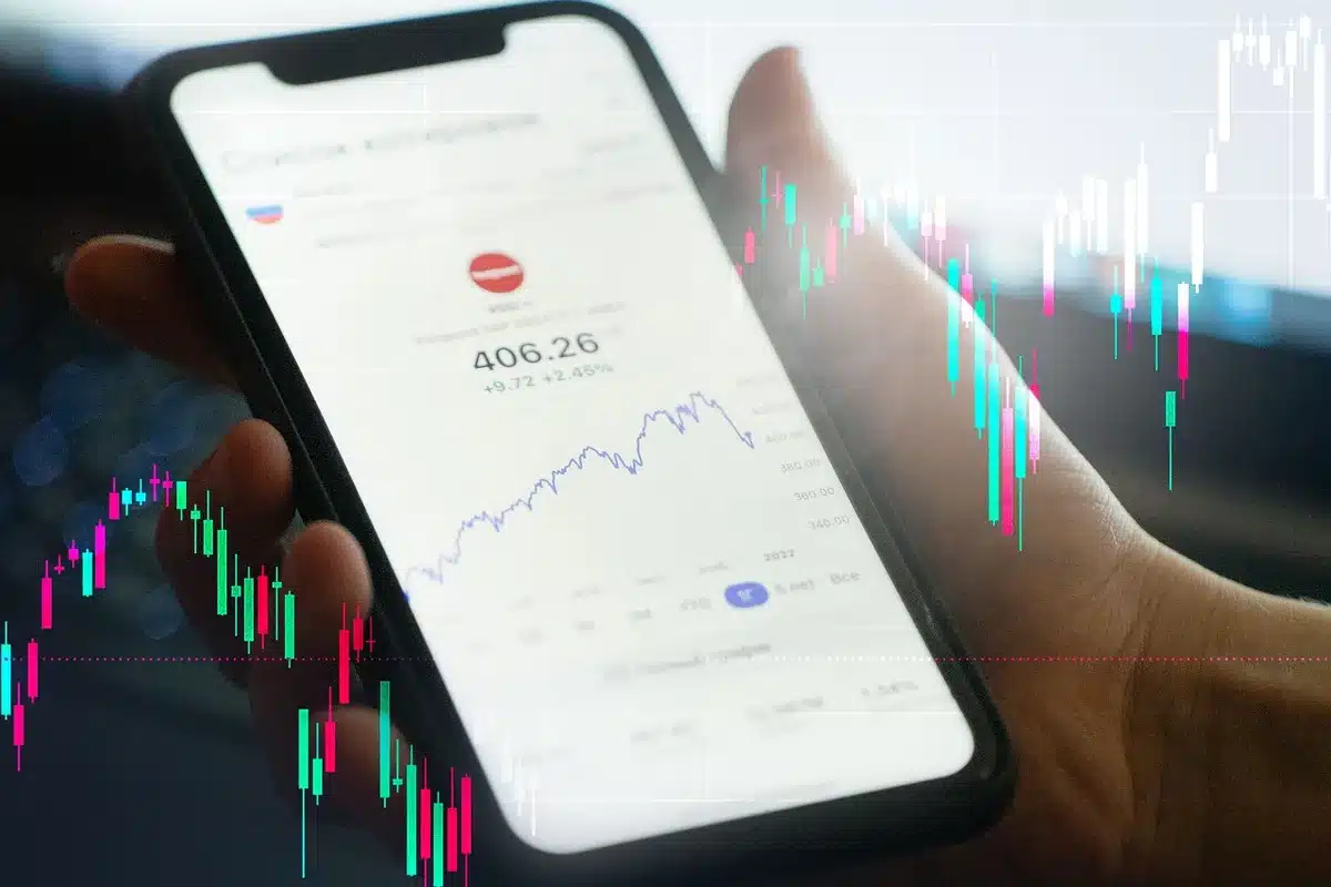 Barras de ouro e gráficos financeiros sobre uma mesa