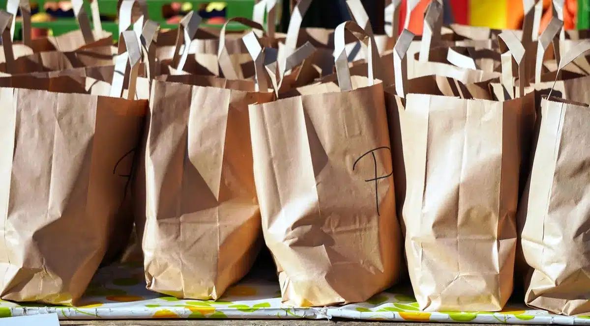Sacos de compras e mercadorias num mercado de verão a representar consumo privado
